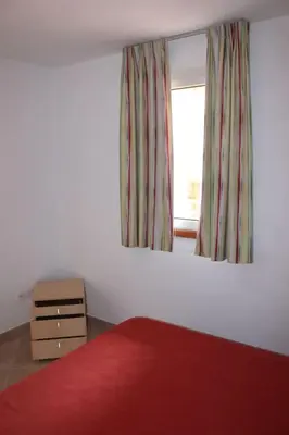 Un ou plusieurs lits dans un hébergement de l'établissement Grazioso bilocale a 200 m dal mare in residence con piscina e WI-FI