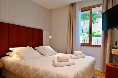 Un ou plusieurs lits dans un hébergement de l'établissement HOTEL SAINT ROCH