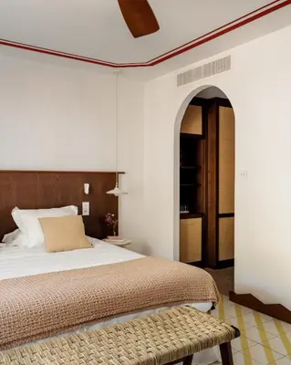 Un ou plusieurs lits dans un hébergement de l'établissement Boutique Hôtel Responsable et Restaurant Basgi Basgi