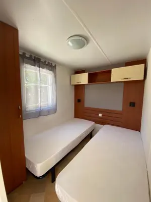 Un ou plusieurs lits dans un hébergement de l'établissement Mobil Home