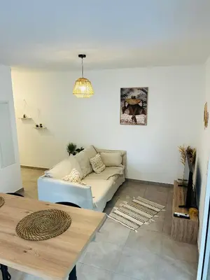 Coin salon dans l'établissement Appartement T2 Corte