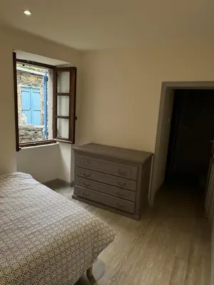 Un ou plusieurs lits dans un hébergement de l'établissement Maison entre mer et montagne à Canari
