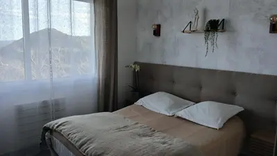 Un ou plusieurs lits dans un hébergement de l'établissement Maison de village 3 chambres vue mer