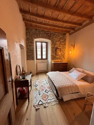 Un ou plusieurs lits dans un hébergement de l'établissement Maison de Caractère au coeur du village