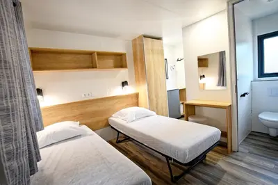 Un ou plusieurs lits dans un hébergement de l'établissement Camping Bella Vista