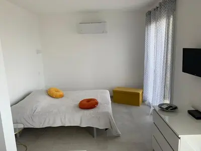 Un ou plusieurs lits dans un hébergement de l'établissement Studio village Brando Cap-Corse