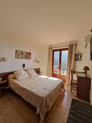 Un ou plusieurs lits dans un hébergement de l'établissement T2 vue mer & montagne Golfe de Porto-Ota