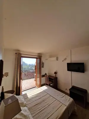 Un ou plusieurs lits dans un hébergement de l'établissement T2 vue mer & montagne Golfe de Porto-Ota