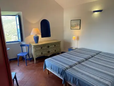 Un ou plusieurs lits dans un hébergement de l'établissement Maison ancienne rénovée avec vue sur mer et Cap Corse