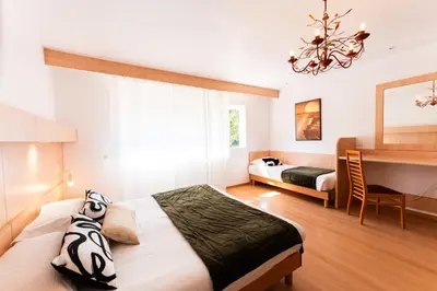 Un ou plusieurs lits dans un hébergement de l'établissement Hotel Arena le Refuge