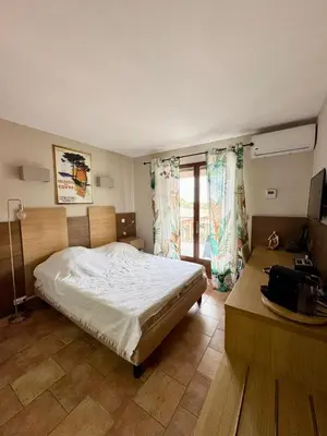 Un ou plusieurs lits dans un hébergement de l'établissement Studio dans résidence avec piscine à Sisco