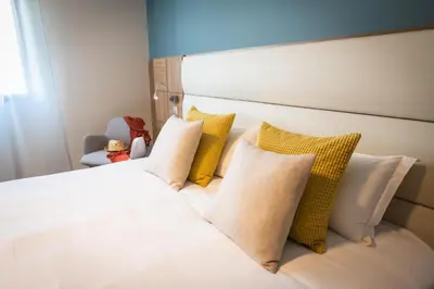 Un ou plusieurs lits dans un hébergement de l'établissement Hotel Port Toga