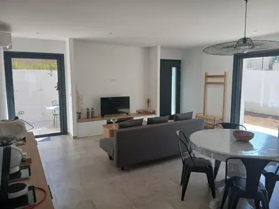 Coin salon dans l'établissement charmante maison neuve proche plage et commerces