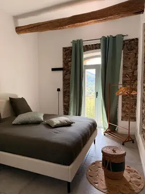 Un ou plusieurs lits dans un hébergement de l'établissement Demeure de charme, appartement du Campu di l altru mondu