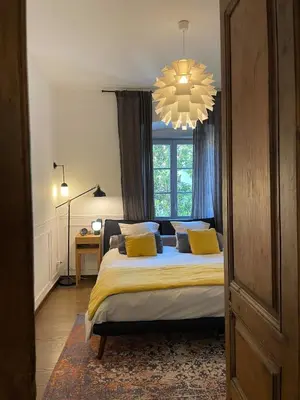 Un ou plusieurs lits dans un hébergement de l'établissement Appartement au charme de l'ancien