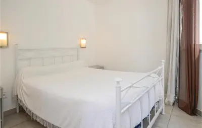Un ou plusieurs lits dans un hébergement de l'établissement Nice Apartment In Moriani Plage