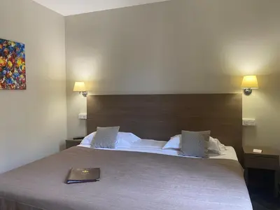 Un ou plusieurs lits dans un hébergement de l'établissement Grand Hôtel De Calvi