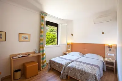 Un ou plusieurs lits dans un hébergement de l'établissement Hotel Kalliste