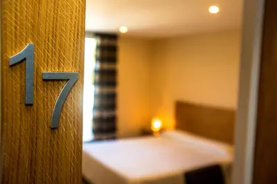 Un ou plusieurs lits dans un hébergement de l'établissement Hotel Cesario