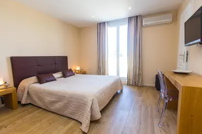Un ou plusieurs lits dans un hébergement de l'établissement Hotel Cesario