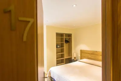 Un ou plusieurs lits dans un hébergement de l'établissement Hotel Cesario