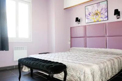 Un ou plusieurs lits dans un hébergement de l'établissement Splendid Hôtel