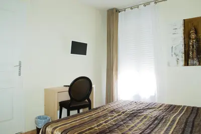 Un ou plusieurs lits dans un hébergement de l'établissement Splendid Hôtel