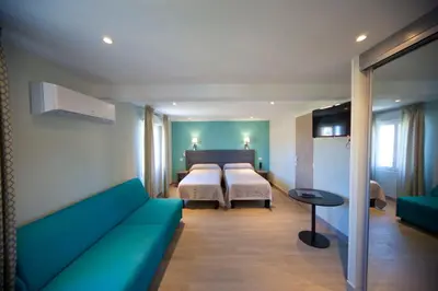 Un ou plusieurs lits dans un hébergement de l'établissement Splendid Hôtel