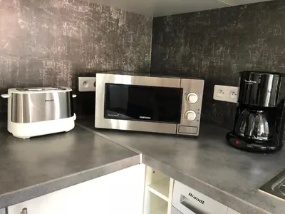 Cuisine ou kitchenette dans l'établissement Charmant F2 dans joli village Corse