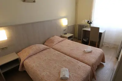 Un ou plusieurs lits dans un hébergement de l'établissement Hotel de La Paix