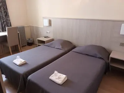 Un ou plusieurs lits dans un hébergement de l'établissement Hotel de La Paix