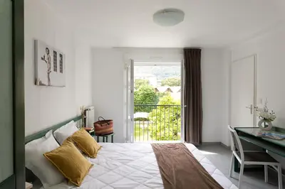 Un ou plusieurs lits dans un hébergement de l'établissement Appart Hotel Corte HR