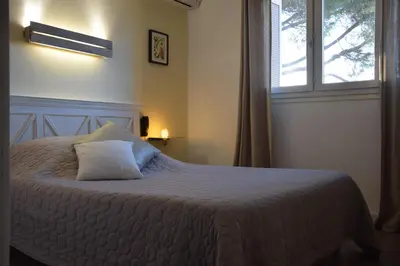 Un ou plusieurs lits dans un hébergement de l'établissement Hôtel le Grillon