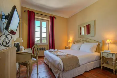 Un ou plusieurs lits dans un hébergement de l'établissement Hôtel Restaurant la Corniche
