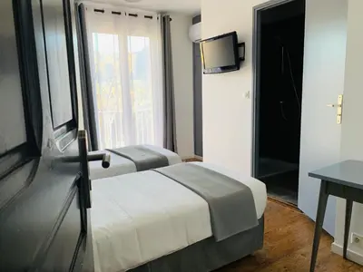 Un ou plusieurs lits dans un hébergement de l'établissement Hôtel les Arbousiers