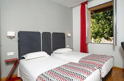 Un ou plusieurs lits dans un hébergement de l'établissement Hôtel Méditerranée