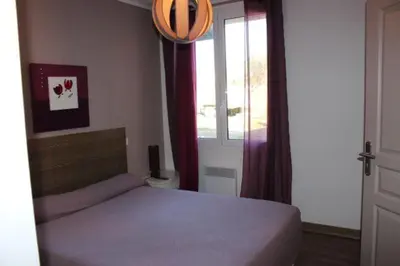Un ou plusieurs lits dans un hébergement de l'établissement Les Orangers