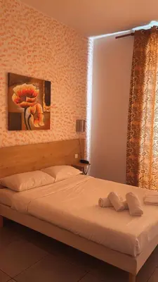 Un ou plusieurs lits dans un hébergement de l'établissement Hotel Riviera