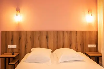 Un ou plusieurs lits dans un hébergement de l'établissement Auberge les Oliviers