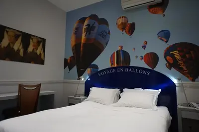 Un ou plusieurs lits dans un hébergement de l'établissement Hôtel Les Voyageurs
