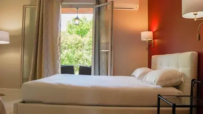 Un ou plusieurs lits dans un hébergement de l'établissement Hôtel Les Jardins