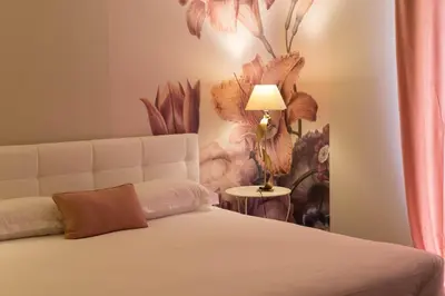 Un ou plusieurs lits dans un hébergement de l'établissement Hôtel Les Jardins