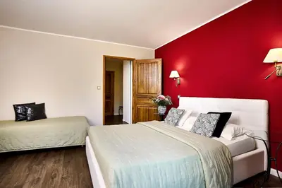 Un ou plusieurs lits dans un hébergement de l'établissement Hôtel Les Jardins