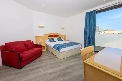 Un ou plusieurs lits dans un hébergement de l'établissement Hotel Saint Christophe