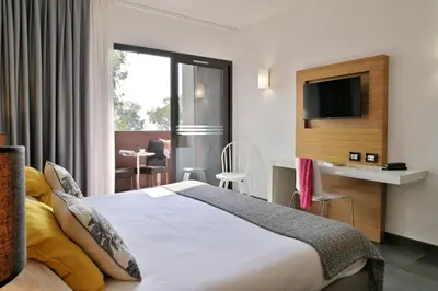 Un ou plusieurs lits dans un hébergement de l'établissement Hôtel San Lucianu