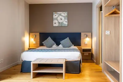 Un ou plusieurs lits dans un hébergement de l'établissement Hôtel Le Bastia