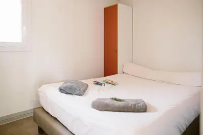 Un ou plusieurs lits dans un hébergement de l'établissement Camping Naturiste Riva Bella 4*
