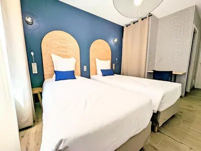 Un ou plusieurs lits dans un hébergement de l'établissement Hôtel Flor