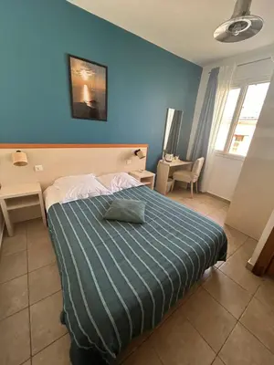 Un ou plusieurs lits dans un hébergement de l'établissement Hôtel de la jetée
