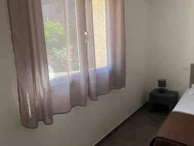 Un ou plusieurs lits dans un hébergement de l'établissement Les Lauriers Roses villa 2